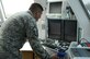 A picture of U.S. Air Force Master Sgt. Samuel Arlia preparing equipment used to communicate between aircraft and airmen on the ground in the tower at Warren Grove Gunnery Range, New Jersey.
