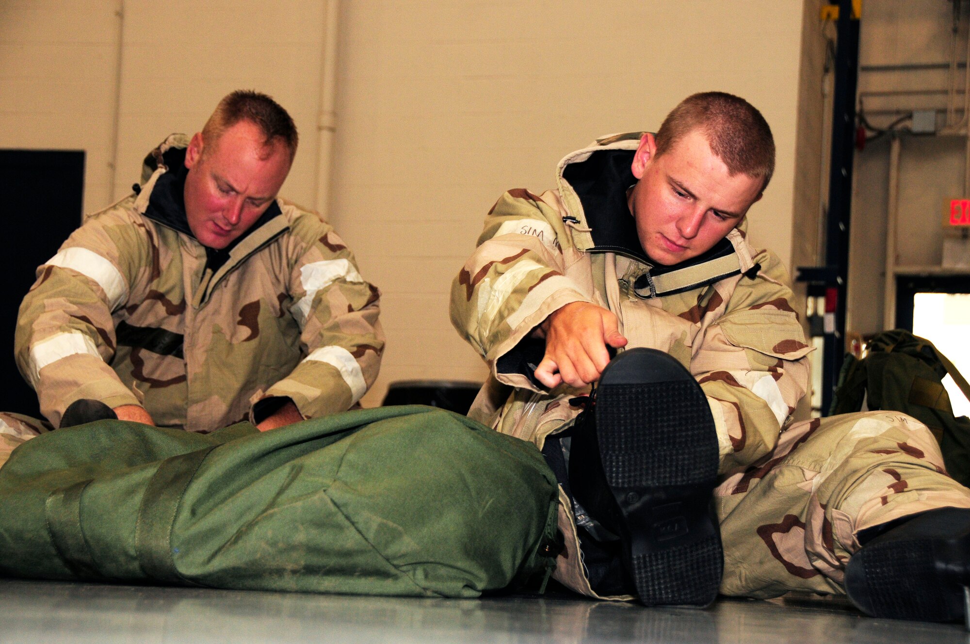 U.S. Air Force Master Sgt. Jedediah Williams and Airman First Class, James Saulnier, members of the 145th Logistics Readiness Squadron, Small Air Terminal, don mission-oriented protective posture gear during Air Expeditionary Skills Rodeo training held at the North Carolina Air National Guard Base, Charlotte Douglas International Airport, Sept. 13, 2015. This training is used by Airmen who are deploying or preparing for inspections. These skills make up the foundation necessary for all Airmen to function effectively in non-conventional hostile environments. (U.S. Air National Guard photo by Master Sgt. Patricia F. Moran, 145th Public Affairs/Released)