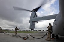 U.S. Marine Corps Cpl. Austin A. Meekins, right, and Cpl. Brian A. Funari, both tiltrotor crew chiefs with Marine Medium Tiltrotor Squadron (VMM) 365, refuel an MV-22B Osprey before parachute exercises at Marine Corps Air Station New River, N.C., Sept. 1, 2015. VMM-365 transported Marines assigned to Marine Raider Regiment as they conducted the exercises.