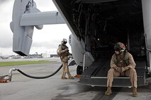 U.S. Marine Corps Cpl. Austin A. Meekins, left, and Cpl. Brian A. Funari, both tiltrotor crew chiefs with Marine Medium Tiltrotor Squadron (VMM) 365, refuel an MV-22B Osprey before parachute exercises at Marine Corps Air Station New River, N.C., Sept. 1, 2015. VMM-365 transported Marines assigned to Marine Raider Regiment as they conducted the exercises.
