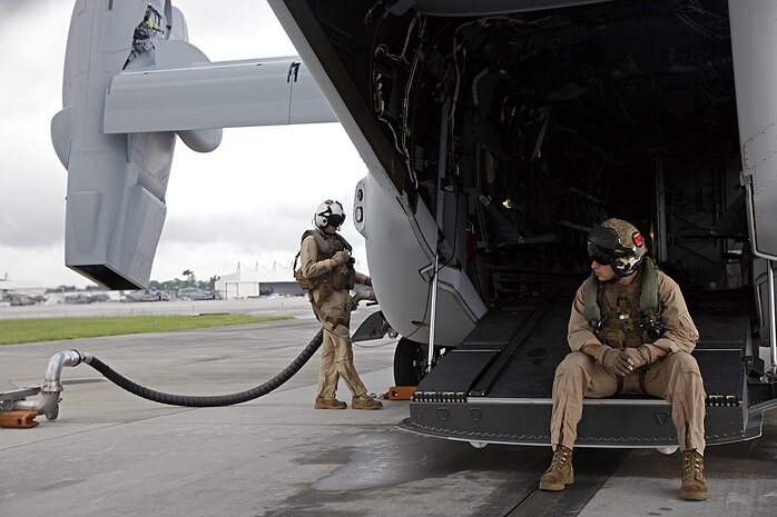 U.S. Marine Corps Cpl. Austin A. Meekins, left, and Cpl. Brian A. Funari, both tiltrotor crew chiefs with Marine Medium Tiltrotor Squadron (VMM) 365, refuel an MV-22B Osprey before parachute exercises at Marine Corps Air Station New River, N.C., Sept. 1, 2015. VMM-365 transported Marines assigned to Marine Raider Regiment as they conducted the exercises.