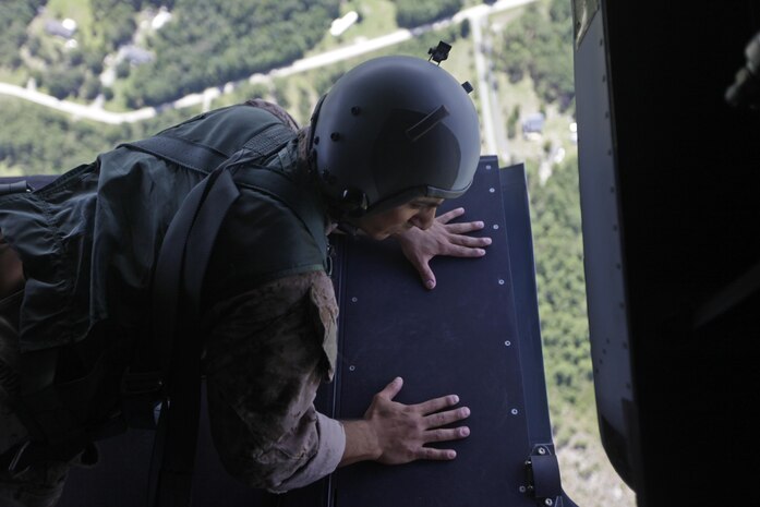 U.S. Marine Corps Sgt. Melvin Rodas, an airborne and air delivery specialist with Marine Raider Regiment, looks for a drop marker from the back of an MV-22B Osprey during parachute exercises above drop zone Pheasant, N.C., Sept. 1, 2015. VMM-365 transported Marines assigned to Marine Raider Regiment as they conducted the exercises.