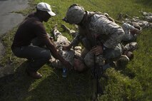U.S. Marines and a civilian assigned to Marine Corps Security Force Regiment, Fleet Antiterrorism Security Team (FAST) Company, Fifth Platoon, participate in a casualty evacuation (CASEVAC) drill near Marine Corps Air Station New River, N.C., Sept. 2, 2015. VMM-365 supported FAST Marines by providing a means of quickly evacuating simulated casualties during a CASEVAC drill.