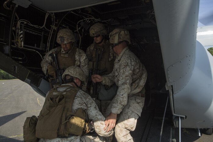 U.S. Marines assigned to Marine Corps Security Force Regiment, Fleet Antiterrorism Security Team (FAST) Company, Fifth Platoon, load simulated casualties into an MV-22B Osprey assigned to Marine Medium Tiltrotor Squadron (VMM) 365, during a casualty evacuation (CASEVAC) drill near Marine Corps Air Station New River, N.C., Sep. 2, 2015. VMM-365 supported FAST Marines by providing a means of quickly evacuating simulated casualties during a CASEVAC drill.
