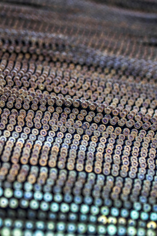 Belts of ammunition cover a table as soldiers prepare to fire the M249 squad assault weapon at the weapons demonstration range on Fort Jackson, S.C., Sept 18, 2015. U.S. Army photo by Sgt. 1st Class Brian Hamilton