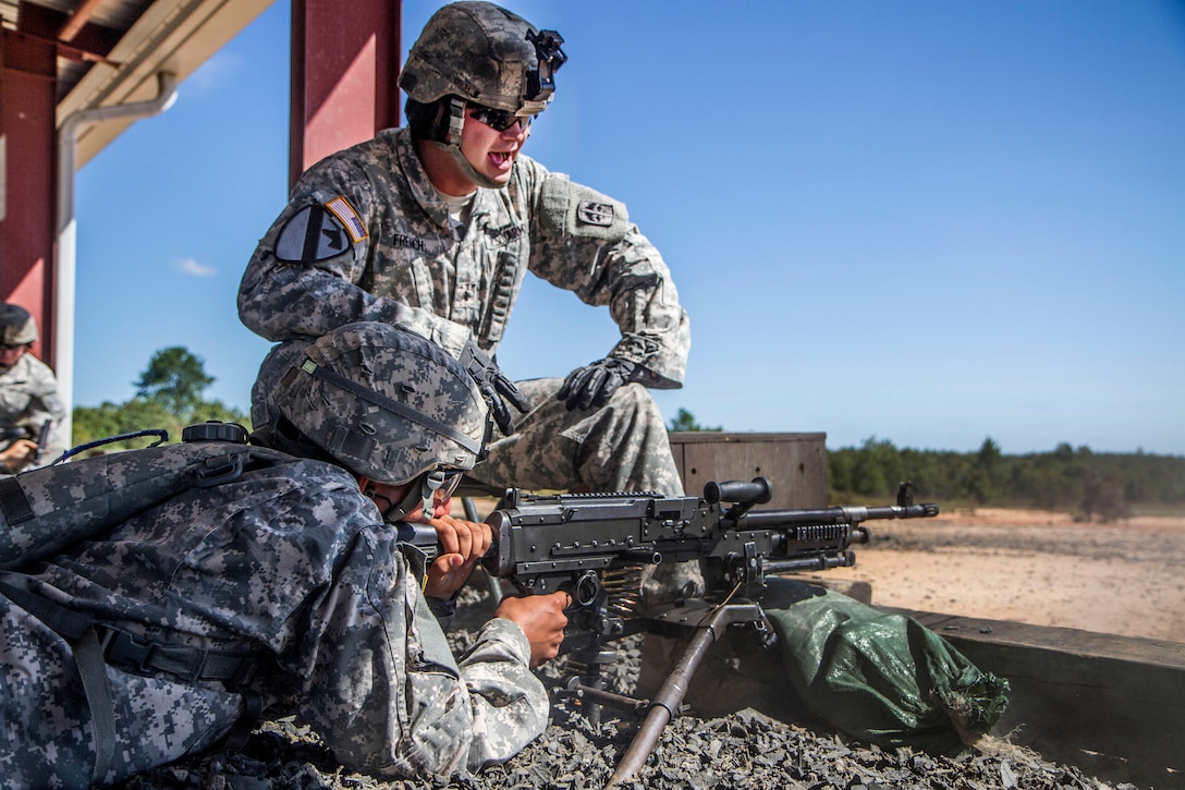 A range cadre yells out instructions to a basic combat training soldier firing a M240 machine gun at the weapons range on Fort Jackson, S.C., Sept. 18, 2015. U.S. Army photo by Sgt. 1st Class Brian Hamilton