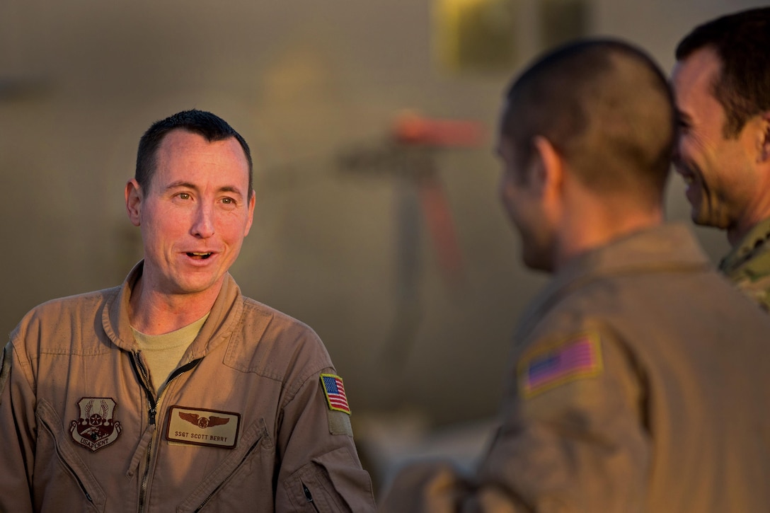 U.S. Air Force Staff Sgt. Scott Berry, left, talks with his crew during an EC-130H Compass Call aircraft final mission meeting on the flight line at Bagram Airfield, Afghanistan, Sept. 6, 2015. Berry is a mission crew supervisor assigned to the 41st Expeditionary Electronic Combat Squadron. The Compass Call is an airborne tactical weapon system using a heavily modified version of the C-130 Hercules airframe. U.S. Air Force photo by Tech. Sgt. Joseph Swafford