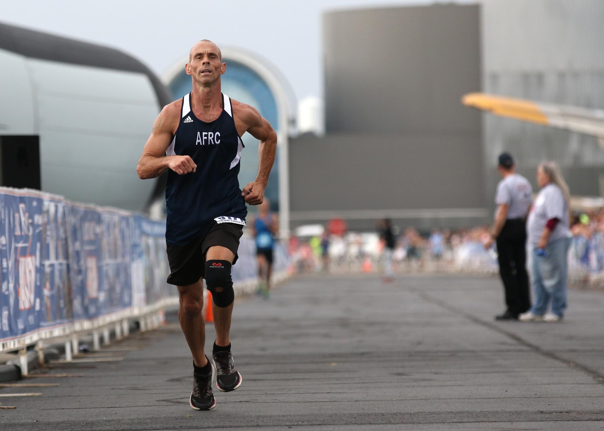 Technical Sgt. Bryan Segrist, 452nd Maintenance Squadron crew chief, March Air Reserve Base, Calif., races toward the finish line in the 19th Annual Air Force Marathon Sept. 19, 2015 at Wright-Patterson AFB, Ohio. Segrist,a member of the Air Force Reserve Command MAJCOM Challenge Team, completed the race in 1:21:43. The team consisted of traditional reservists, air reserve technicians, individual mobilization augmentees and Air Guard Reserve members. The MAJCOM challenge included six Airmen participating in the half marathon and four in the full marathon. (U.S. Air Force photo /Tech. Sgt. Patrick O’Reilly) 