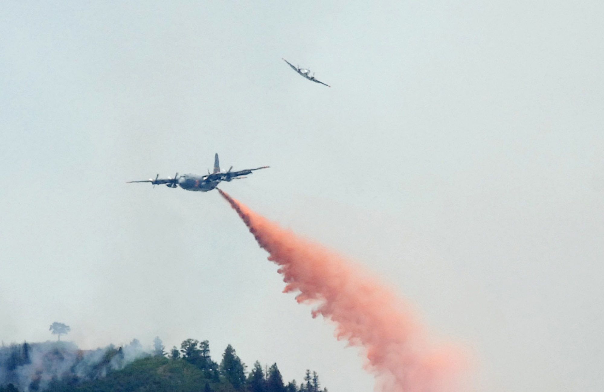 COLORADO SPRINGS, Colo. - A U.S. Forest Service lead plane C90 King Air breaks away as a Modular Airborne Firefighting System-equipped C-130 begins dropping retardant on a section of the Waldo Canyon fire near Colorado Springs, Colo. (U.S. Air Force photo by Tech. Sgt. Thomas J. Doscher)