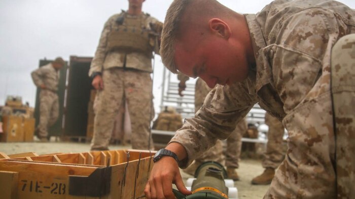 An anti-tank missileman with Combined Anti-Armor Team (CAAT) Red within Battalion Landing Team (BLT) 2/1, the ground combat element for the 13th Marine Expeditionary Unit, perfoms pre-fire inspections on a Tube-launched, Optically-tracked, Wire-guided (TOW) Missile before he and fellow Marines practice hunter-killer techniques on Aug. 21, 2015. The CAAT, composed of heavy machine gunners and anti-tank missilemen, is used to combat hardened targets as well as provide security. 