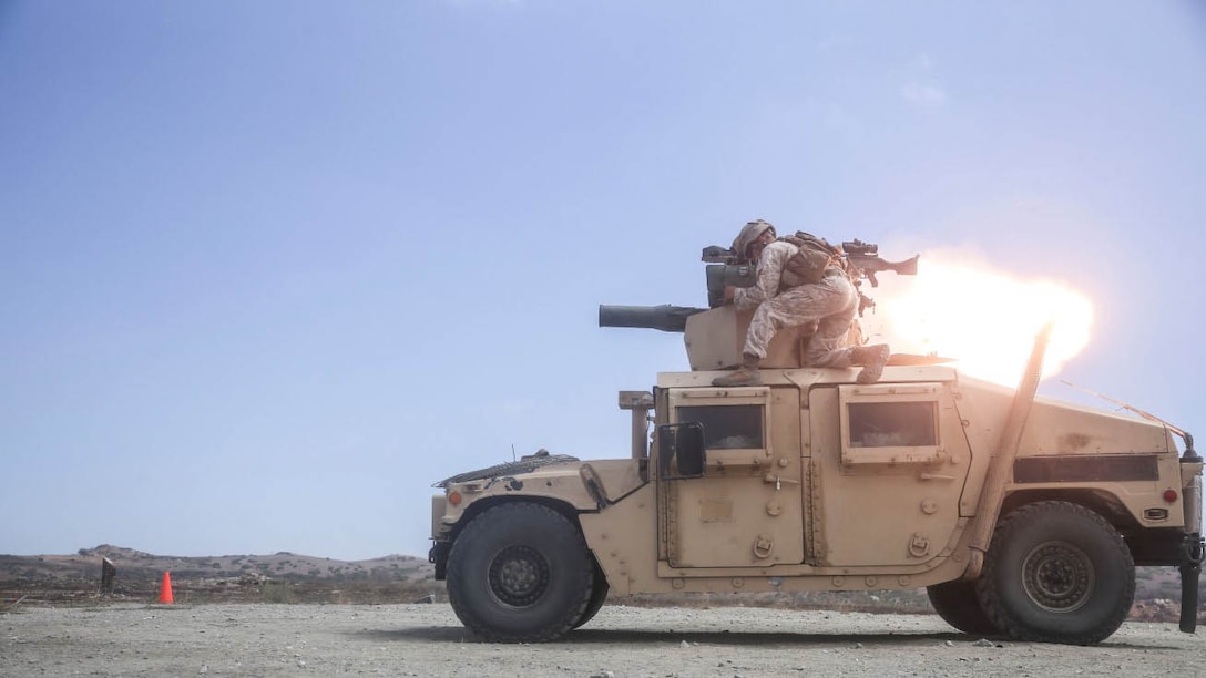 Cpl. Benjamin Mayberry, an anti-tank missileman with the Combined Anti-Armor Team (CAAT) within Battalion Landing Team (BLT) 2/1, the ground combat element for the 13th Marine Expeditionary Unit, braces as another missileman fires a Tube-launched, Optically-tracked,Wire-guided (TOW) missile during sustainment training with multiple platforms on Aug. 21, 2015. The CAAT, composed of heavy machine gunners and anti-tank missilemen, is used to combat hardened targets as well as provide security. 