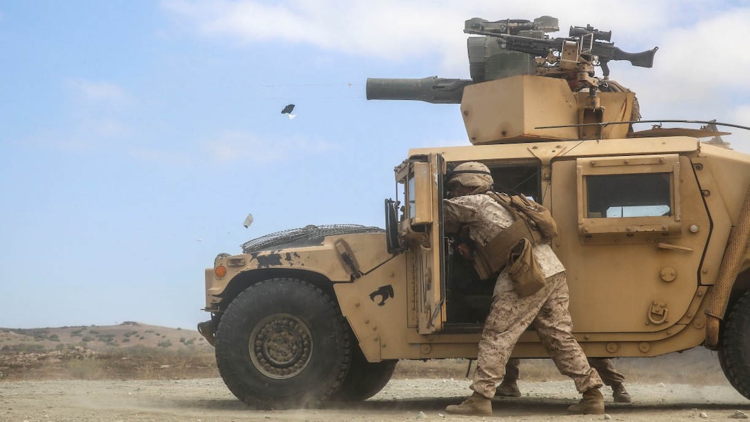 U.S. Marines with the Combined Anti-Armor Team (CAAT) within Battalion Landing Team (BLT) 2/1, the ground combat element for the 13th Marine Expeditionary Unit, remain braced for fire while holding radio antennae out of the back-blast area of a TOW missile during sustainment training on Aug. 21, 2015. The CAAT, composed of heavy machine gunners and anti-tank missilemen, is used to combat hardened targets as well as provide security. 