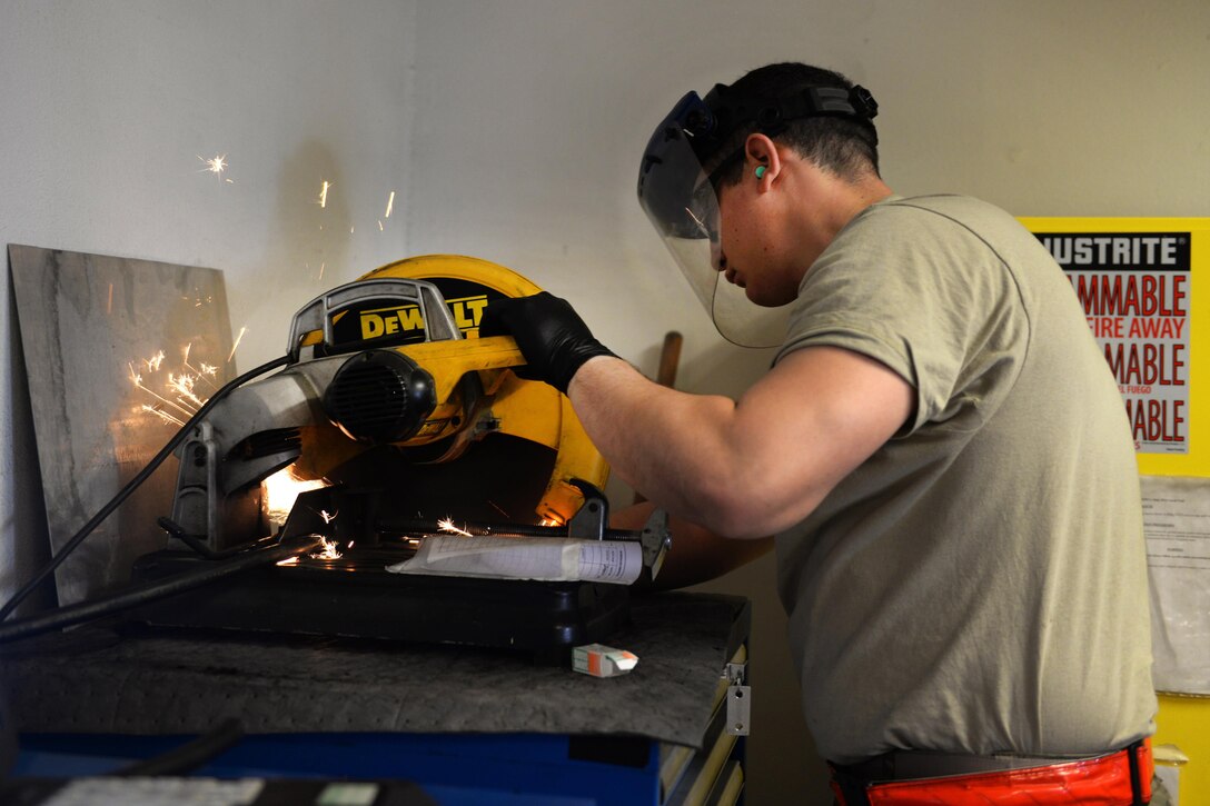 U.S. Air Force Staff Sgt. Jesus Rodriguez-Cruz trims a hose to be put on a hydraulics system in an F-16 Fighting Falcon aircraft at Bagram Airfield, Afghanistan, Sept. 7, 2015. Rodriguez-Cruz, an aircraft hydraulics specialist with the 455th Expeditionary Maintenance Squadron, is responsible for repairing the hydraulics parts from the landing gear for the F-16. U.S. Air Force photo by Senior Airman Cierra Presentado