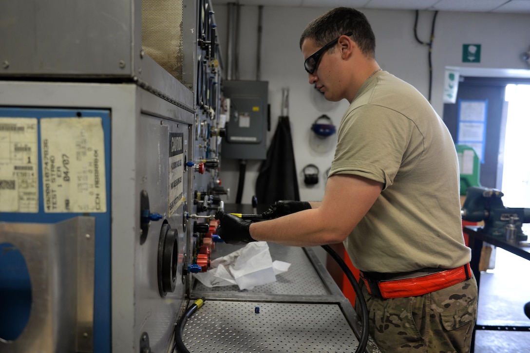 U.S. Air Force Staff Sgt. Jesus Rodriguez-Cruz performs a test on a hose that will be put on a hydraulics system in an F-16 Fighting Falcon aircraft at Bagram Airfield, Afghanistan, Sept. 7, 2015. Rodriguez-Cruz, an aircraft hydraulics specialist with the 455th Expeditionary Maintenance Squadron, is responsible for repairing the hydraulics parts from the landing gear for the F-16. U.S. Air Force photo by Senior Airman Cierra Presentado