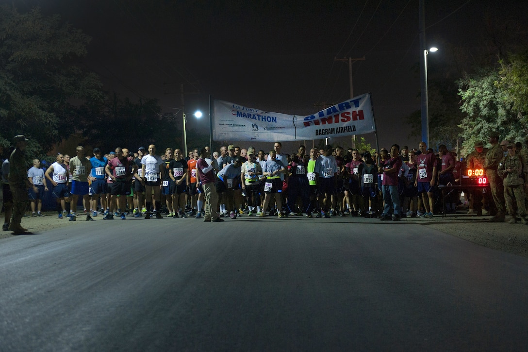 U.S. service members, civilians and coalition partners wait at the starting line for the beginning of the Air Force Marathon and Air Force Half Marathon on Bagram Airfield, Afghanistan, Sept. 19, 2015. This year marked the seventh year that the Air Force sanctioned deployed location races overseas. U.S. Air Force photo by Tech. Sgt. Joseph Swafford