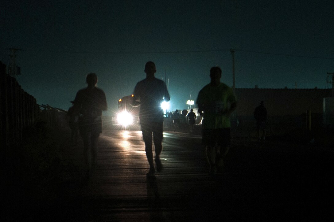 U.S. service members run during the Air Force Marathon and Air Force Half Marathon on Bagram Airfield, Afghanistan, Sept. 19, 2015. U.S. Air Force photo by Tech. Sgt. Joseph Swafford