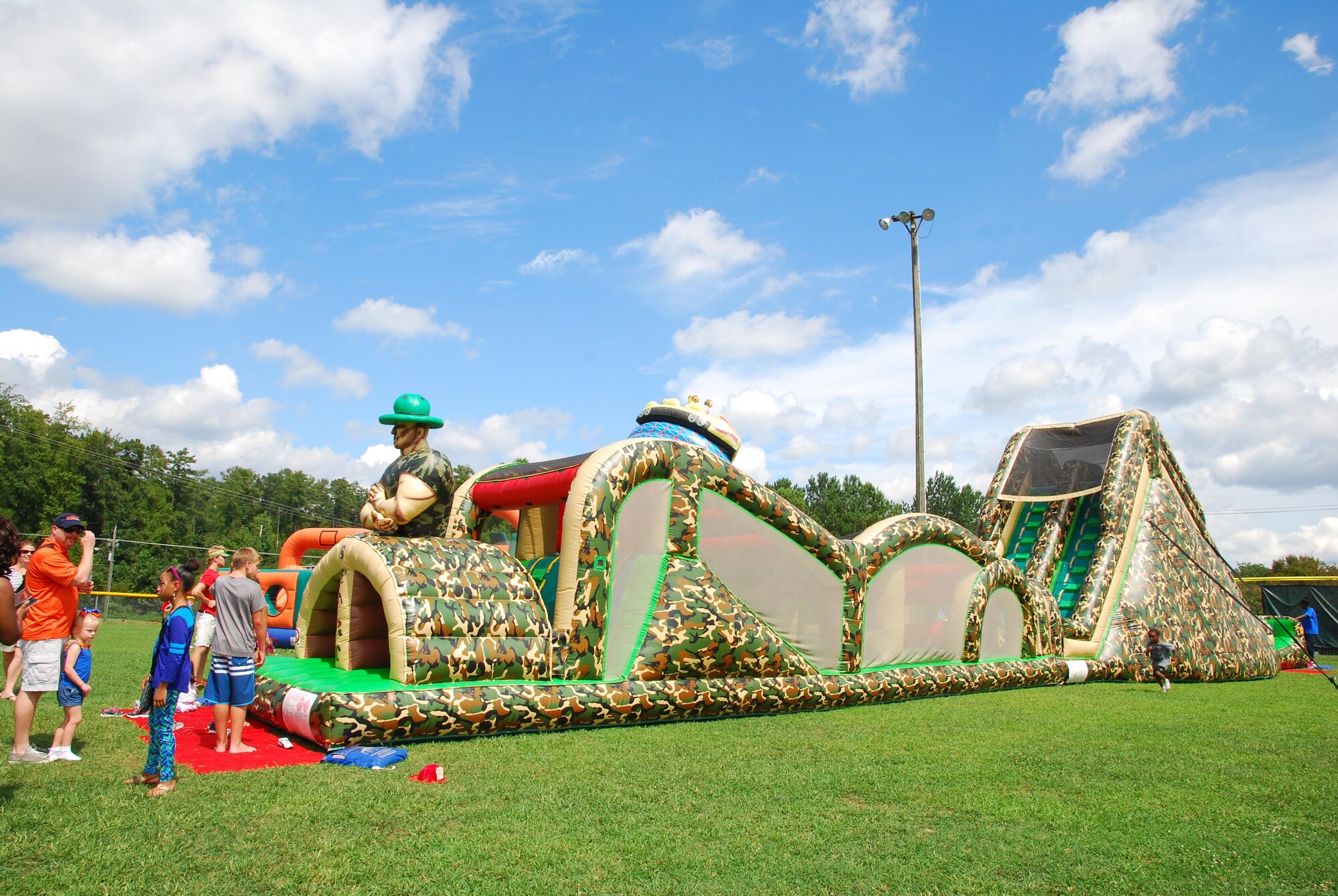 Children of 94th Airlift Wing members enjoy jump castles at the 2015 Wing Family Day Sept. 12, 2015 at the Dobbins Lakeside Recreation Area at Dobbins Air Reserve Base, Ga. Attendees enjoyed music, food, dunking booths, exhibits, vendors, auctions, face painting, pet adoption and raffles. (U.S. Air Force photo/Staff Sgt. Jaclyn McDonald)