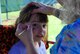 Gia, daughter of 94th Airlift Wing member Tech. Sgt. Jason Millett, gets a purple butterfly painted on her face at the 2015 Wing Family Day Sept. 12, 2015 at the Dobbins Lakeside Recreation Area at Dobbins Air Reserve Base, Ga. Attendees enjoyed music, food, dunking booths, exhibits, vendors, auctions, jump castles, face painting, pet adoption and raffles. (U.S. Air Force photo/Staff Sgt. Jaclyn McDonald)