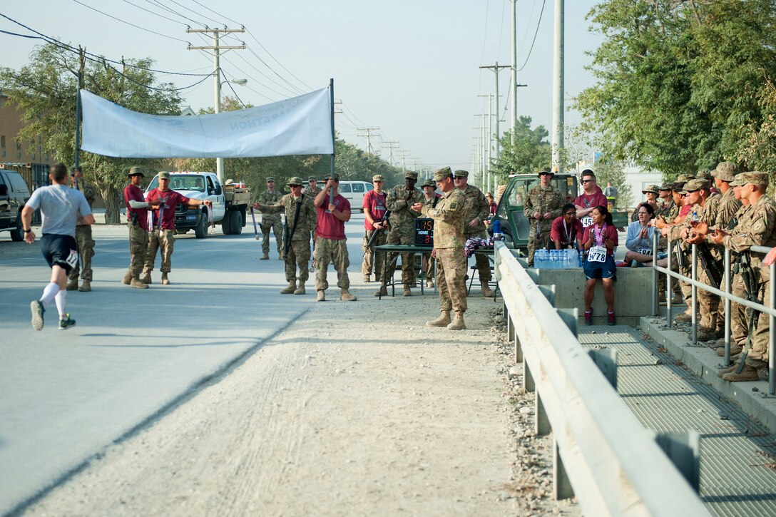 U.S. service members cheer on runners at the finish line of the Air Force Marathon on Bagram Airfield, Afghanistan, Sept. 19, 2015. U.S. Air Force photo by Tech. Sgt. Joseph Swafford
