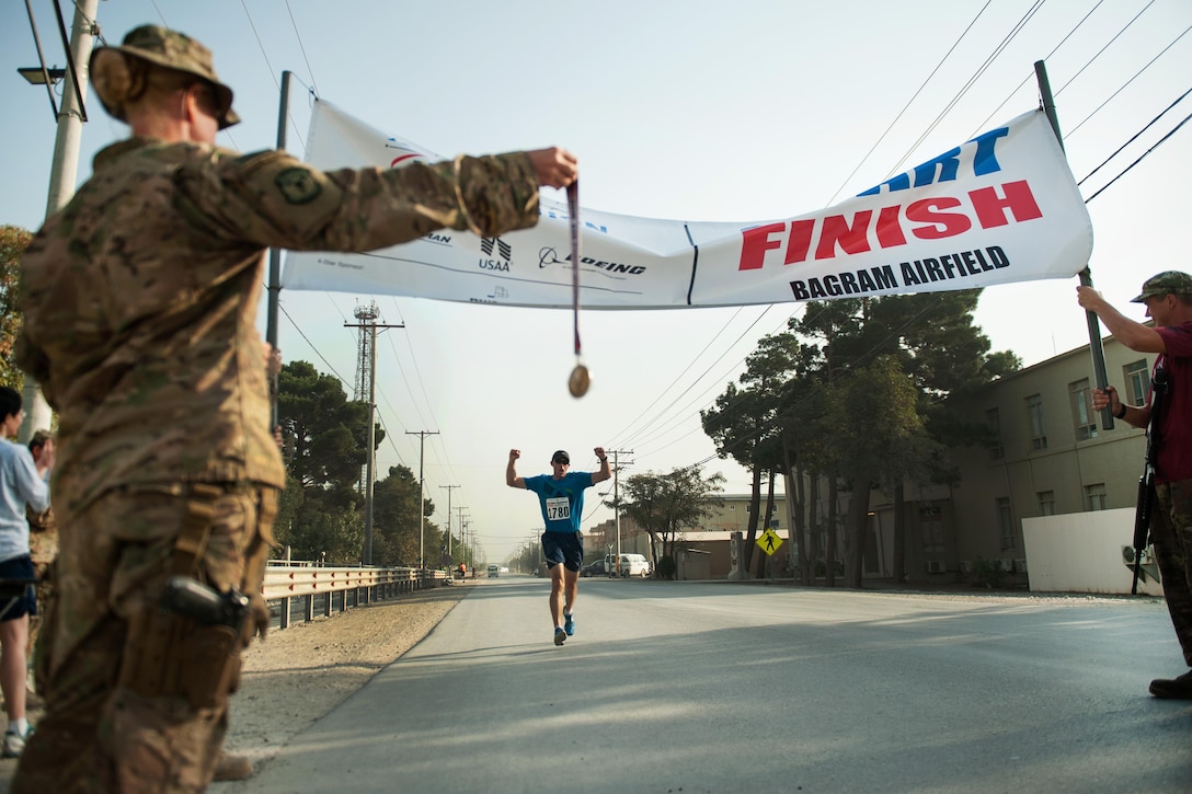 A U.S. service member runs to the finish line during the Air Force Marathon on Bagram Airfield, Afghanistan, Sept. 19, 2015. U.S. Air Force photo by Tech. Sgt. Joseph Swafford