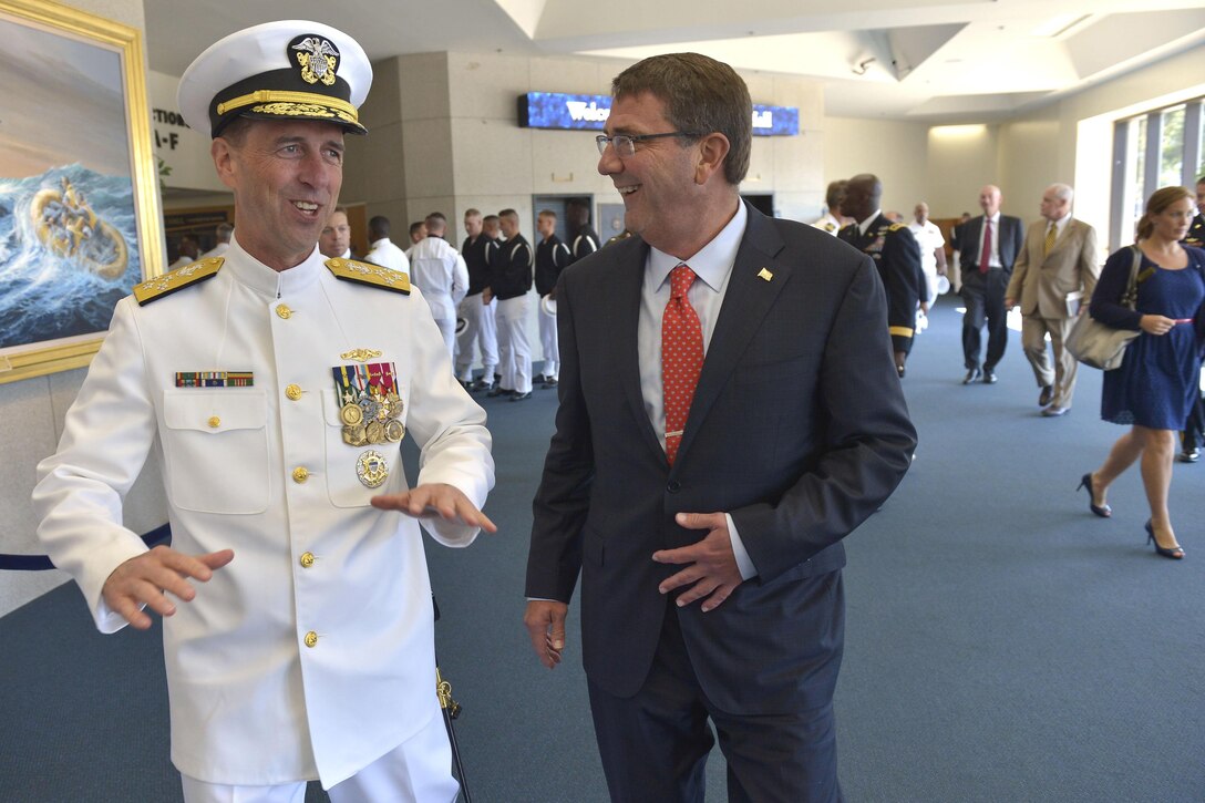 Defense Secretary Ash Carter shares a light moment with incoming Chief of Naval Operations Adm. John Richardson after a change-of-office ceremony at the U.S. Naval Academy in Annapolis, Md., Sept. 18, 2015. Richardson replaced Adm. Jonathan Greenert, who retired after 40 years of service as a naval officer. DoD photo by Glenn Fawcett
