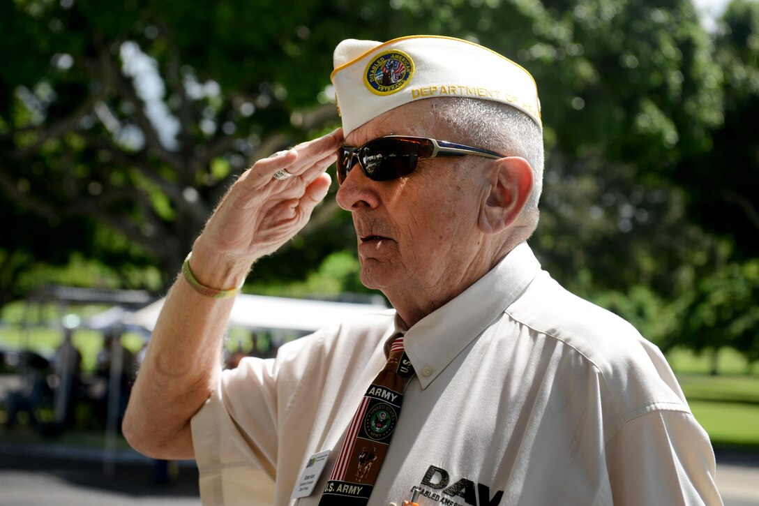 Robert Kent, a member of  Disabled American Veterans,  salutes to the playing of TAPS during the National Prisoner of War/Missing in Action Recognition Day ceremony at the National Memorial Cemetery of the Pacific in Honolulu, Sept. 18, 2015. U.S. Army photo by Sgt. Richard DeWitt