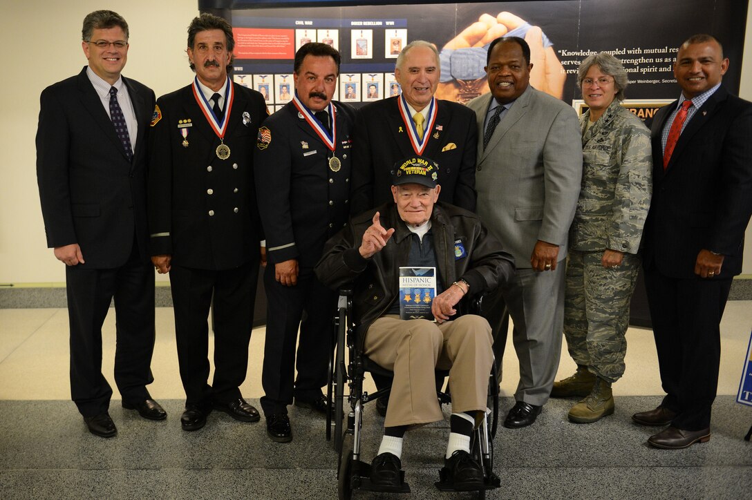 Rick Leal, top center, president of the Hispanic Medal of Honor Society, and society and audience members pose for a photo during the Hispanic Medal of Honor ribbon-cutting ceremony for a new display at the Pentagon, Sept. 18, 2015. DoD photo by Marvin Lynchard