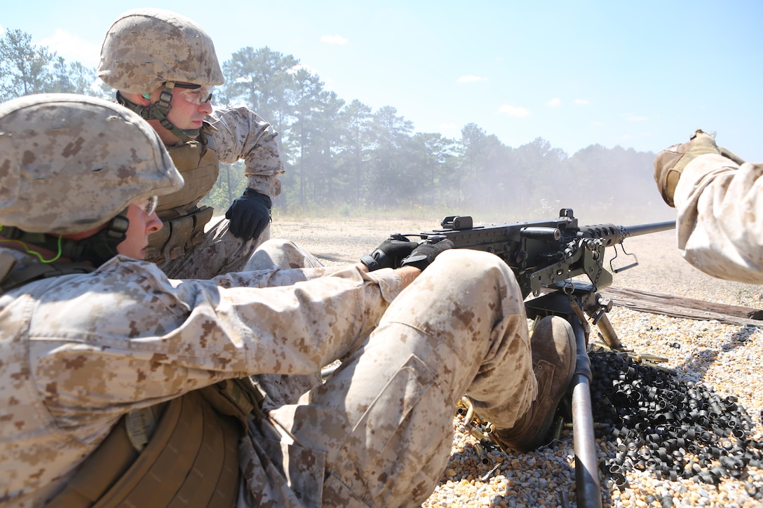Lance Cpl. Joshua Arntzen (front), a radio operator with Battery M, 3rd Battalion, 14th Marine Regiment, Marine Forces Reserve and Cpl. Jeffrey Mallone, a field wireman with Battery M, man the M250 machine gun on Pelham Range in Anniston, Alabama on Sept. 19, 2015. The Marines trained on three different crew-served weapons to maintain their proficiency and knowledge on each system.