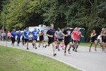 Participants in the inaugural "Splash-and Dash" athletic competition run to raise awareness for suicide prevention at Saluda Shoals Park, Columbia, South Carolina, Sept. 12, 2015. The South Carolina National Guard hosted the event to recognize September as national suicide awareness prevention month. 