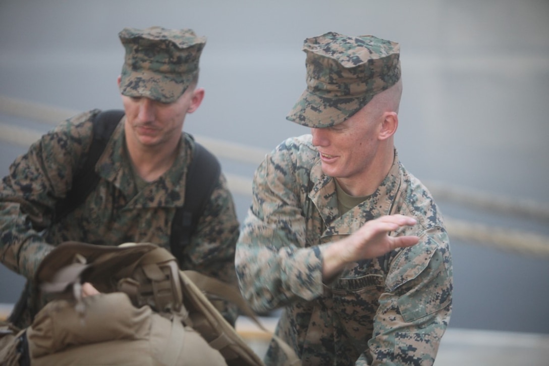 Sgt. Joshua L. Pugh, a radio technician for Koa Moana 15-3, and Sgt. Christopher D. Altis, a disbursing agent for KM 15-3, unload gear as they prepare to embark the USNS Lewis and Clark in Charleston, S.C., Sept. 1. Marines with KM 15-3 recently departed for a three month deployment across the Asian Pacific Ocean.