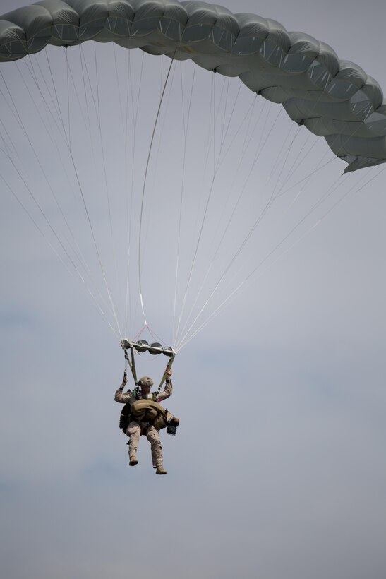 A Marine Raider with U.S. Marine Corps Forces, Special Operations Command, parachutes with a Multi-Purpose Canine over Marine Corps Base Camp Lejeune, N.C., Sept. 10, 2015. As MARSOC continues to demonstrate their versatile capabilities, MPC handlers with the command are preparing their canines to maneuver in new areas of operation. 