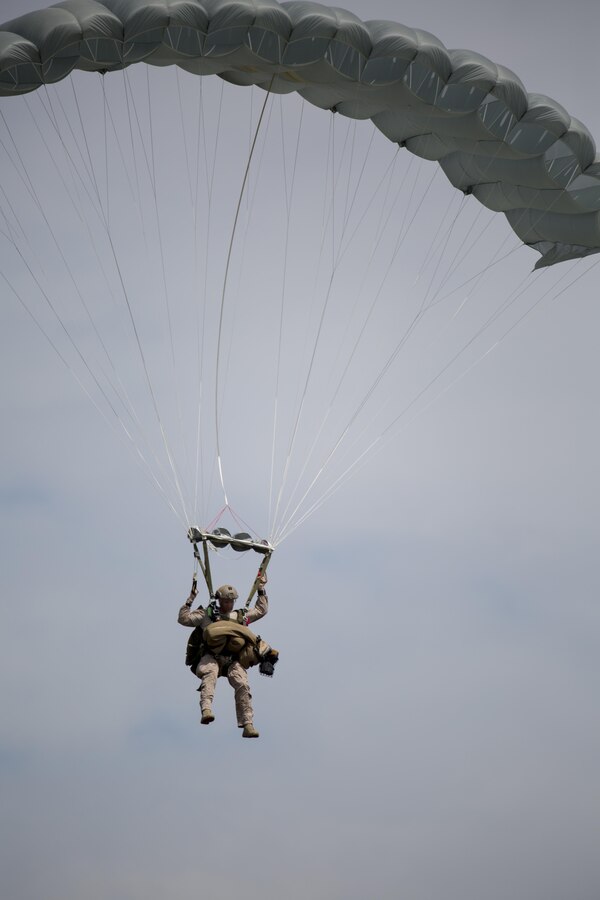 A Marine Raider with U.S. Marine Corps Forces, Special Operations Command, parachutes with a Multi-Purpose Canine over Marine Corps Base Camp Lejeune, N.C., Sept. 10, 2015. As MARSOC continues to demonstrate their versatile capabilities, MPC handlers with the command are preparing their canines to maneuver in new areas of operation. 