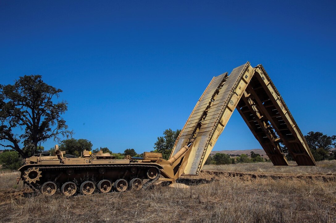 Marines with 1st Combat Engineer Battalion, 1st Marine Division, I Marine Expeditionary Force, deploy an assault vehicle launched bridge during Exercise Pioneer Express aboard Camp Roberts, Calif., Sept. 1, 2015. The exercise will ensure that the Marines and Sailors of the battalion will remain effective through complex training evolutions and detailed evaluations. (U.S. Marine Corps photo by Lance Cpl. Caitlin Bevel)