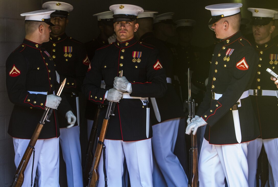 Marines with the Silent Drill Platoon inspect their uniforms before their performance at Citi Field in Flushing, N.Y., Sept. 19, 2015. The ceremonial unit show-cased a series of precise drill movements without verbal commands before a New York Mets and Yankees game.   The 24-man rifle-platoon is based out of Marine Barracks Washington, D.C.  (U.S. Marine Corps Photo by Sgt. Zachary W. Scanlon/Released)