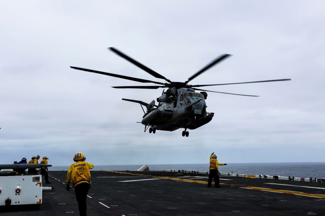 U.S. Navy landing enlisted signalmen guide a CH-53E Super Stallion aboard the amphibious assault ship USS Boxer during Exercise Dawn Blitz 2015, Aug. 31, 2015. Dawn Blitz is a multinational amphibious training exercise designed to train Expeditionary Strike Group Three, 1st Marine Expeditionary Brigade and Coalition partners in the operations expected of an amphibious task force while also building U.S. and Coalition operational interoperability from the sea. (U.S. Marine Corps photo by Lance Cpl. April L. Price/Released)