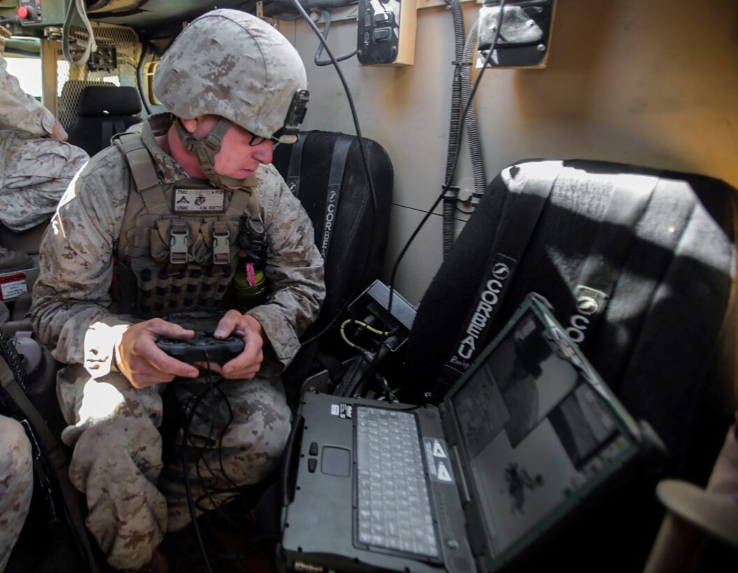 Lance Cpl. Alec Smith, a combat engineer with Mobility Assault Company, 1st Combat Engineer Battalion, 1st Marine Division and an Elcho, Wis., native remotely operates a PackBot to place a block of C4 explosives for blow-in-place operations during Exercise Pioneer Express aboard Camp Roberts, Calif., Sept. 4, 2014. The exercise provides an opportunity for both individual and collective training for the Marines and the unit and ensures they remain equipped, ready and relevant for future operations. (U.S. Marine Corps photo by Lance Cpl. Caitlin Bevel)