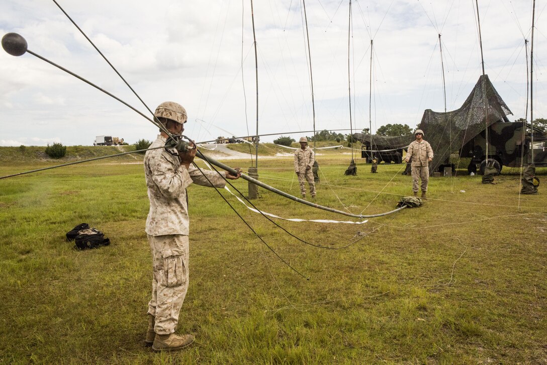 Marines with 10th Marine Regiment, 2nd Marine Division set up an antenna for communication during Operation Firestorm, an exercise to prepare the regiment for their upcoming exercise, Rolling Thunder, at Camp Lejeune, N.C., Aug. 16, 2015. The operation is a week-long field operation and is designed to ensure that communication and logistics capabilities are up to par before pushing out to Fort Bragg for Rolling Thunder. (U.S. Marine Corps photo by Cpl. Krista James/Released)