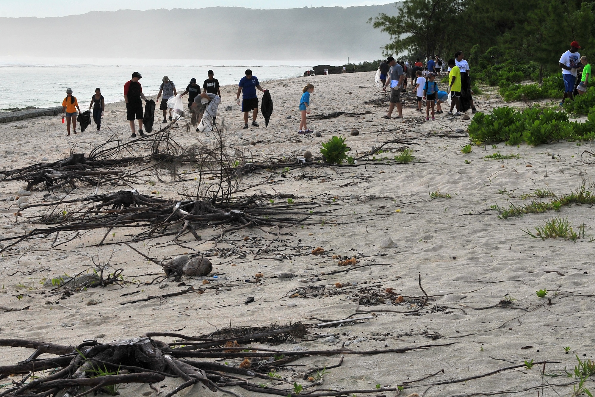 Members of Team Andersen participate in Guam’s 20th International Coastal Cleanup Sept. 19, 2015, at Tarague Beach on Andersen Air Force Base, Guam. More than 140 volunteers collected 22 bags of trash and 10 bags of recyclables from the base beach during the annual event. (U.S. Air Force photo by Tech. Sgt. Melissa B. White/Released)