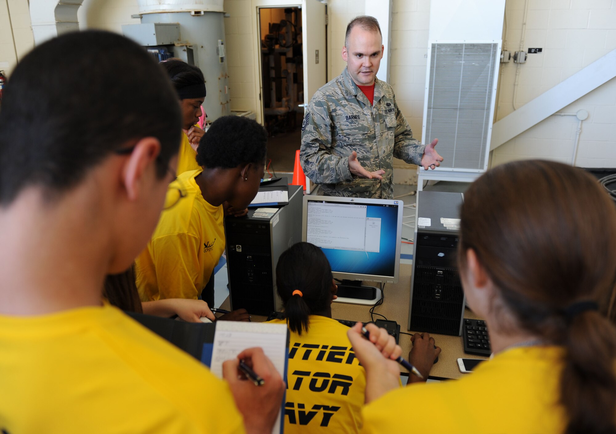 Tech. Sgt. Brandon Barnes, 336th Training Squadron cyber systems operations instructor, explains how a computer hard drive can be used to search for files for evidence leading to causes or motives of crimes during the STEM (science, technology, engineering and mathematics) Diversity Outreach Day Sept. 18, 2015, at the fuel cell hangar, Keesler Air Force Base, Miss. The event consisted of 10 Mississippi gulf coast high school Junior ROTC units and science students viewing a staged crime scene, participating in a “brainiacs” test and visiting informative booths about Air Force opportunities and accession requirements with an emphasis on STEM. (U.S. Air Force photo by Kemberly Groue)