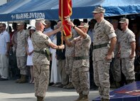 Sergeant Maj. William T. Sowers (left), sergeant major of the 1st Marine Division, hands the division colors to Brig. Gen. Daniel D. Yoo (center) during the change of command ceremony in which Yoo passed on command of the division to Maj. Gen. Daniel J. O’Donohue (right) aboard Marine Corps Base Camp Pendleton, Calif., Sept. 10, 2015. O’Donohue is taking command of the division after recently commanding Marine Corps Forces Cyberspace Command. (U.S. Marine Corps photo by Staff Sgt. Bobbie A. Curtis)