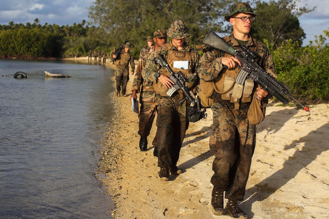 U.S. Marines march on a beach with troops from Tonga and New Zealand and French service members from New Caledonia during their culminating event for Exercise Tafakula on Tongatapu Island, Tonga, Sept. 9, 2015. The Marines are with Bravo Company, 1st Battalion, 4th Marine Regiment, Marine Rotational Force–Darwin. U.S. Marine Corps photo by Cpl. Angel Serna

