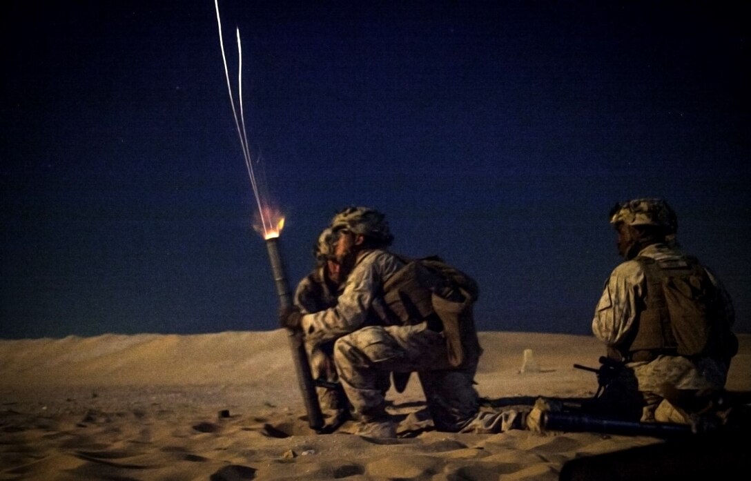KUWAIT (Aug. 25, 2015) U.S. Marines with Lima Company, Battalion Landing Team 3rd Battalion, 1st Marine Regiment, 15th Marine Expeditionary, fire a round from an M224 60mm lightweight mortar during a live-fire training exercise. Elements of the 15th MEU are ashore in Kuwait for sustainment training to maintain and enhance the skills they developed during their pre-deployment training period.  The 15th MEU is embarked aboard the Essex Amphibious Ready Group and deployed to maintain regional security in the U.S. 5th Fleet area of operations. (U.S. Marine Corps photo by Cpl. Elize McKelvey/ Released)