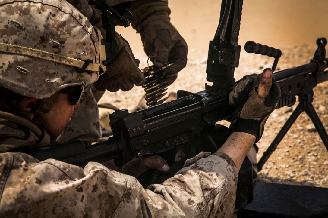KUWAIT (Aug. 26, 2015)  U.S. Marines with Lima Company, Battalion Landing Team 3rd Battalion, 1st Marine Regiment, 15th Marine Expeditionary Unit, reload an M249 squad automatic weapon during a live-fire training exercise. Elements of the 15th MEU are ashore in Kuwait for sustainment training to maintain and enhance the skills they developed during their pre-deployment training period.  The 15th MEU is embarked aboard the Essex Amphibious Ready Group and deployed to maintain regional security in the U.S. 5th Fleet area of operations. (U.S. Marine Corps photo by Cpl. Elize McKelvey/Released)