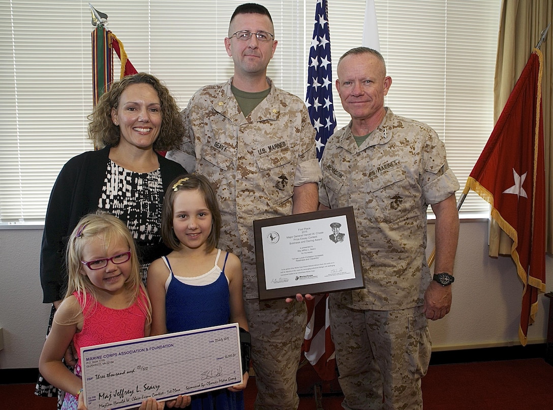 The Marine Corps Association selected Maj. Jeffrey L. Seavy’s essay “A Free Lunch – Cohesion Increases Readiness and Capability” for the 2015 Maj. Gen. Harold W. Chase Essay Contest. The annual contest recognizes Marines who through bold and daring thought argue for new and better ways of doing business within the Marine Corps. Lt. Gen. Lawrence D. Nicholson, commanding general of III Marine Expeditionary Force presented the plaque and $3,000 check to Seavy, Sept. 21 on Okinawa, Japan. Seavy, a native of Cedar Rapids, Iowa, is the deputy director of the III MEF Defense Policy Review Initiative. His essay will be published in the Marine Corps Gazette.