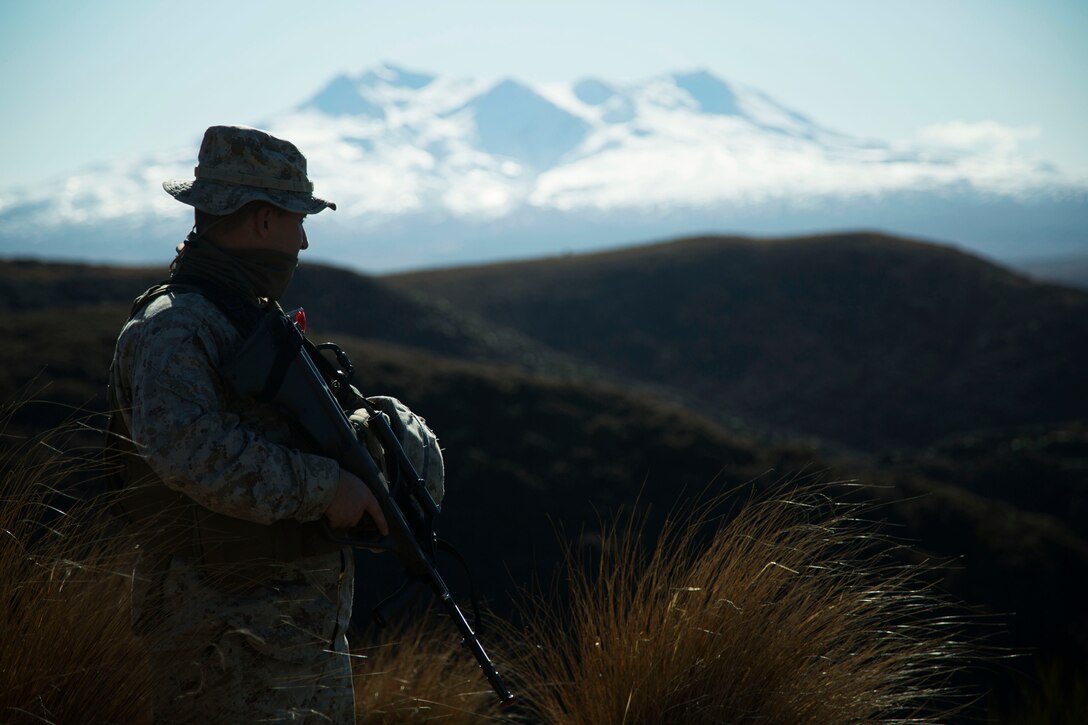 U.S. Marine Maj. Ryan Von Rembow, from Fayetteville, Arizona, surveys the impact area at Waiouru Military Training Area, New Zealand, during exercise Joint Assault Signals Company Black, Aug. 27, 2015. Kiwi soldiers and U.S. Marines collectively called for fire utilizing 81mm mortars. They conducted immediate neutralization, danger close, smoke and coordinated illuminated missions. Kiwi soldiers are with 161 Battery, 16th Field Regiment. Von Rembow is a forward air controller officer with 5th Air Naval Gunfire Liaison Company, III Marine Expeditionary Force Headquarters Group, III MEF.
