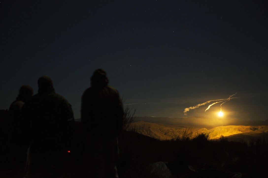New Zealand Army Soldiers and U.S. Marines watch illumination coordination rounds light the impact area at Waiouru Military Training Area, New Zealand, during exercise Joint Assault Signals Company Black, Aug. 28, 2015. Kiwi soldiers and U.S. Marines collectively called for fire utilizing 81mm mortars. The illumination rounds provide visibility on the impact area at night in order to efficiently adjust the rounds onto target. Kiwi soldiers are with 161 Battery, 16th Field Regiment.  Marines are with 5th Air Naval Gunfire Liaison Company, III Marine Expeditionary Force Headquarters Group, III MEF.