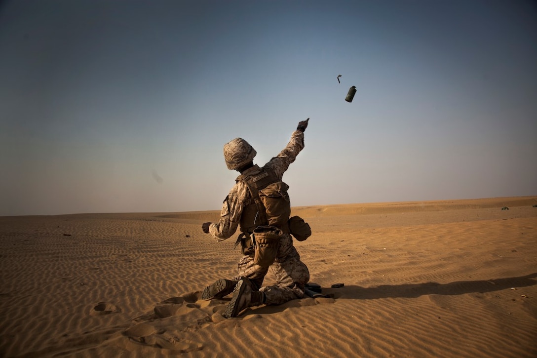 U.S. Marine Lance Cpl LaVone Singleton throws a smoke grenade downrange during a live-fire training exercise. Singleton is a rifleman with Lima Company, Battalion Landing Team 3rd Battalion, 1st Marine Regiment, 15th Marine Expeditionary Unit. Elements of the 15th MEU are ashore in Kuwait for sustainment training to maintain and enhance the skills they developed during their pre-deployment training period.  The 15th MEU is embarked aboard the Essex Amphibious Ready Group and deployed to maintain regional security in the U.S. 5th Fleet area of operations. (U.S. Marine Corps photo by Cpl. Elize McKelvey/Released)