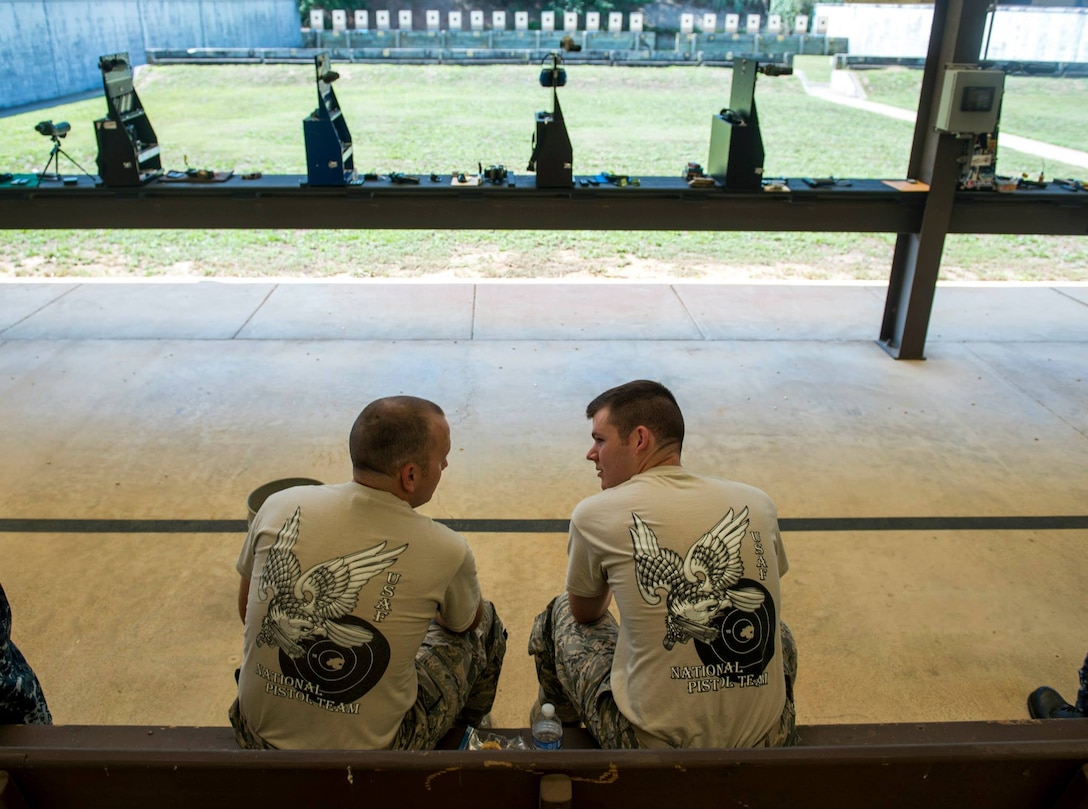 Air Force 2nd Lt. Tucker Sears, right, the 436th Logistics Readiness Squadron material management officer in charge, and his brother, Staff Sgt. Terrence Sears, the Air Force National Pistol Team noncommissioned officer in charge, talk between matches at the Annual Interservice Pistol Championships June 8, 2015, at Fort Benning, Ga. The event was Tucker’s first as a team member, and the team placed fifth out of 13 teams. U.S. Air Force photo by Staff Sgt. Andrew Lee