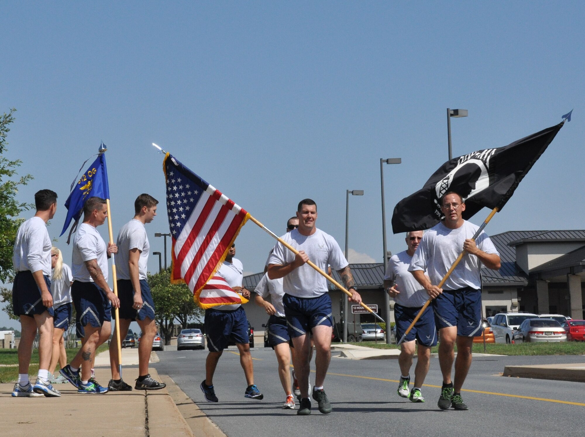 Reservists and active-duty Airmen from Team Dover take turns running laps around the base flag pole in observance of POW/MIA Recognition Day Sept.18, 2015, at Dover Air Force Base, Del. The event honors the nation's past and present prisoners of war and missing in action, while also highlighting the U.S. government's commitment to account for them. (U.S. Air Force photo/Staff Sgt. Joe Yanik)
