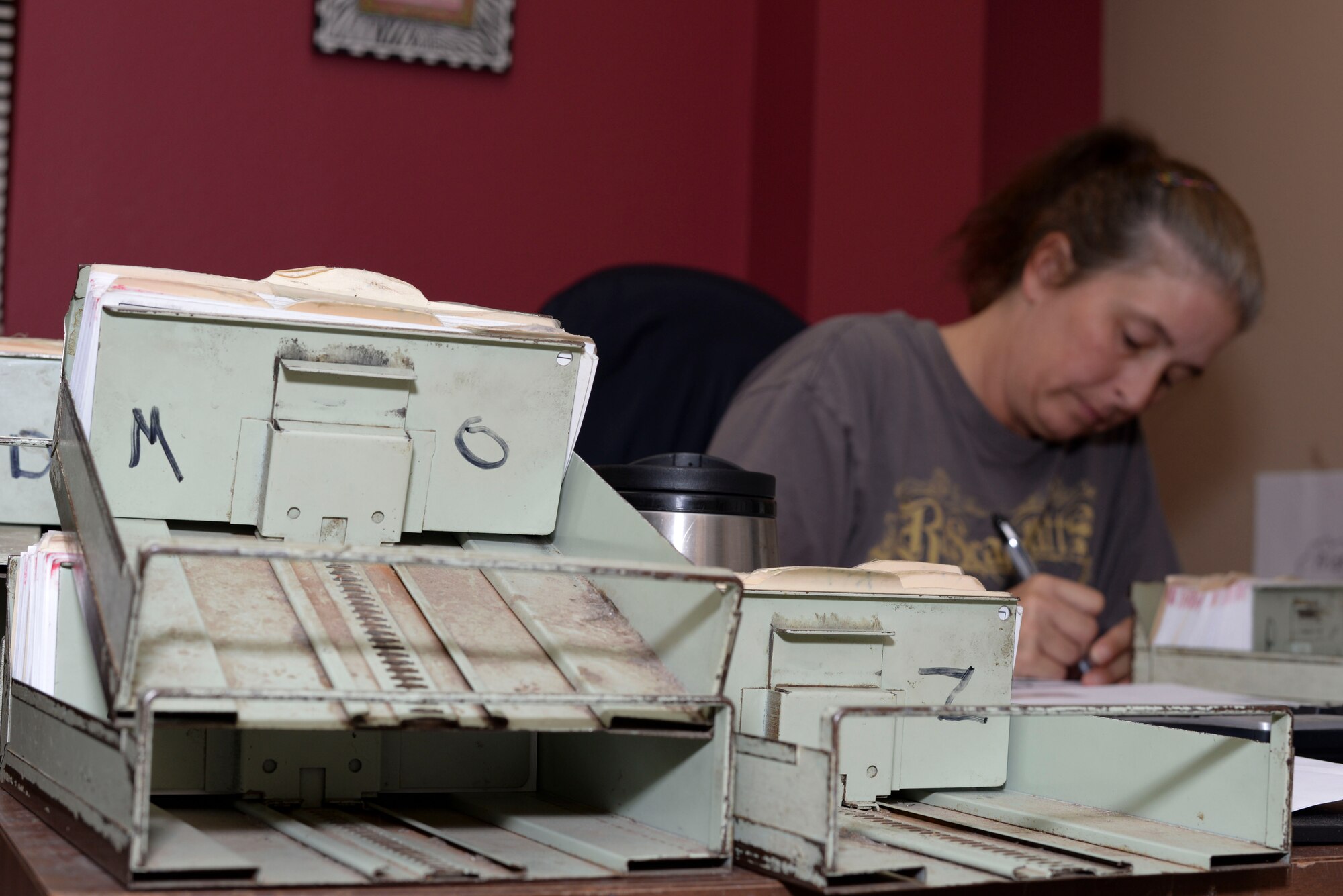 Kim Thompson, 2nd Communications Squadron assistant postal center manager, alphabetizes mail at Barksdale Air Force Base, La., Sept. 3, 2015. Postal center employees must sort through piles of mail to ensure it is delivered to the correct person. (U.S. Air Force photo/Senior Airman Amanda Morris)